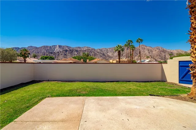 a view of a backyard with plants and patio