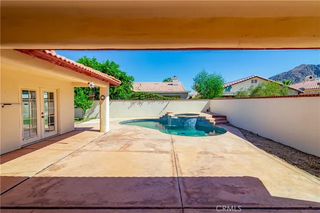 a view of swimming pool with a lounge chairs