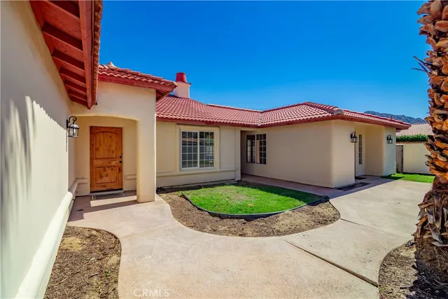 a bathroom with a granite countertop toilet sink and mirror