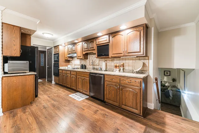a kitchen with stainless steel appliances granite countertop a refrigerator sink and cabinets