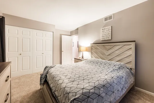 a bedroom with a bed and a lamp