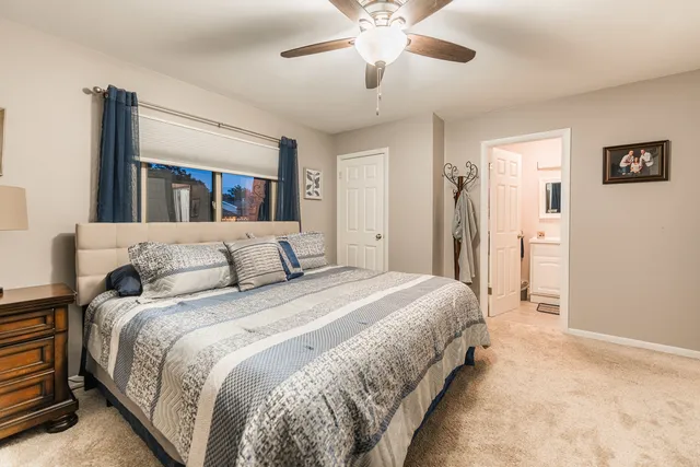 a spacious bedroom with a bed and a chandelier
