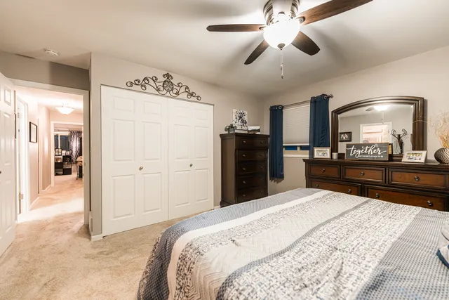 a large bedroom with a bed and a chandelier