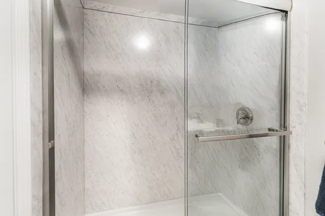 a bathroom with a glass shower door