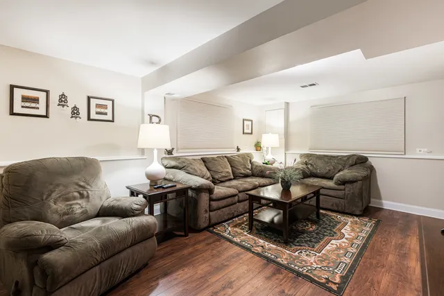a living room with furniture rug and wooden floor