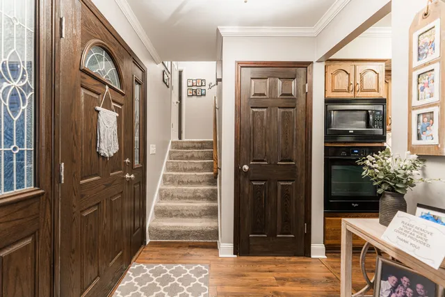 a view of a hallway with wooden floor and entryway