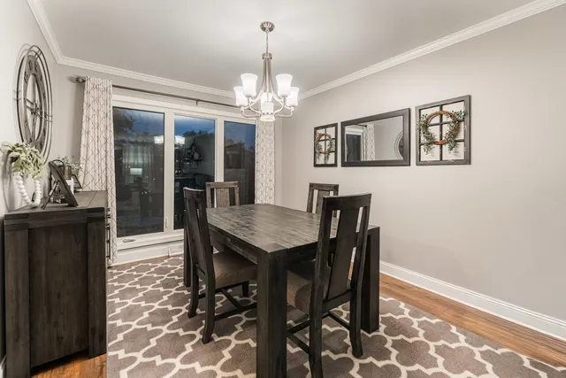 a view of a dining room with furniture and a chandelier