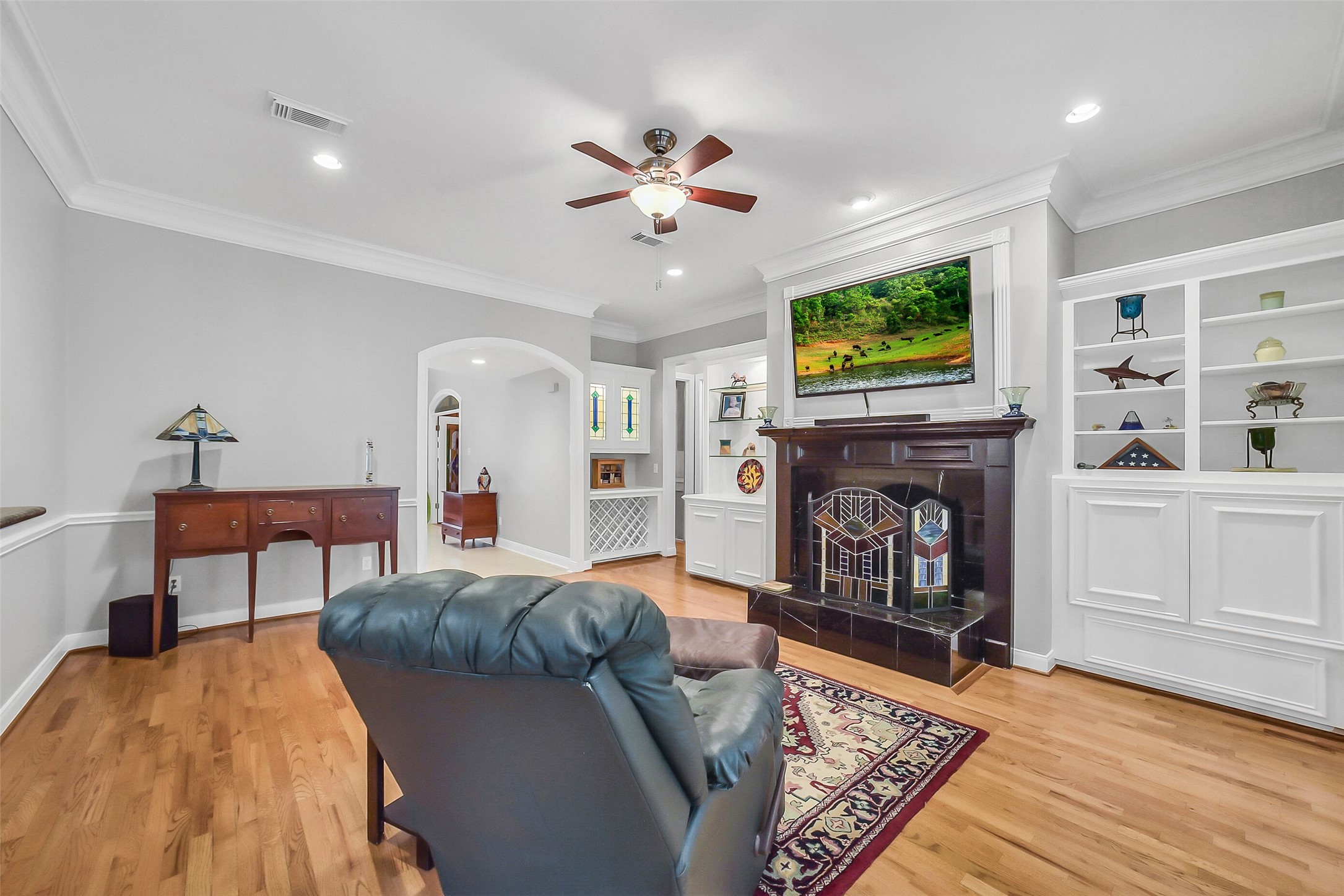 1260 Fries Road Houston, TX 77055 - Photo 8 of 42 Custom Built-In Shelving with wine Bar and Accent Lighting with Splashes of Custom Stained wood and Crown Molding! Just Beautiful!