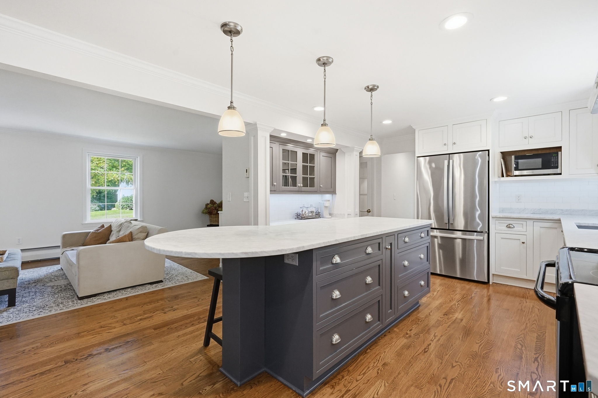 6 Cornfield Road Simsbury, CT 06070 - Photo 9 of 40 Gorgeous remodeled kitchen with high-end white inset cabinetry, carrara marble countertops, white subway tile, stainless steel appliances, an enormous island that can accommodate 4 barstools, a built-in hutch and a pantry.