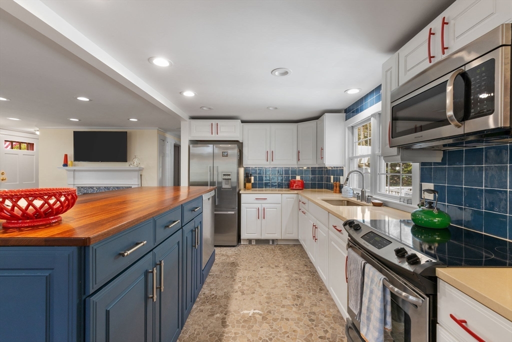68 Gorham Road Harwich, MA 02646 - Photo 13 of 33 a kitchen with stainless steel appliances granite countertop a stove a sink and a refrigerator