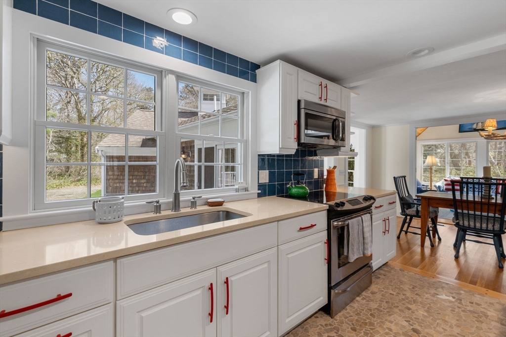 68 Gorham Road Harwich, MA 02646 - Photo 14 of 33 a kitchen with stainless steel appliances granite countertop a sink and a stove