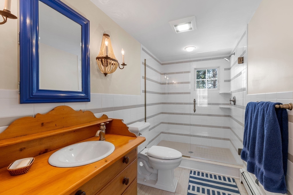 68 Gorham Road Harwich, MA 02646 - Photo 19 of 33 a bathroom with a sink a toilet and a mirror
