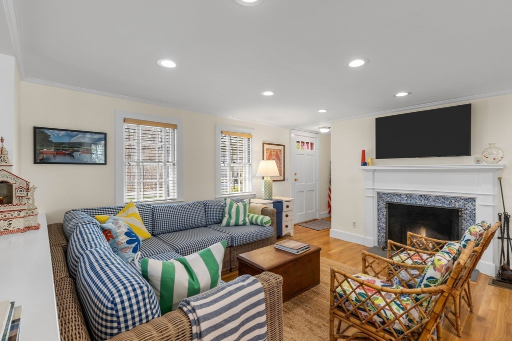 68 Gorham Road Harwich, MA 02646 - Photo 7 of 33 a living room with furniture a flat screen tv and a fireplace