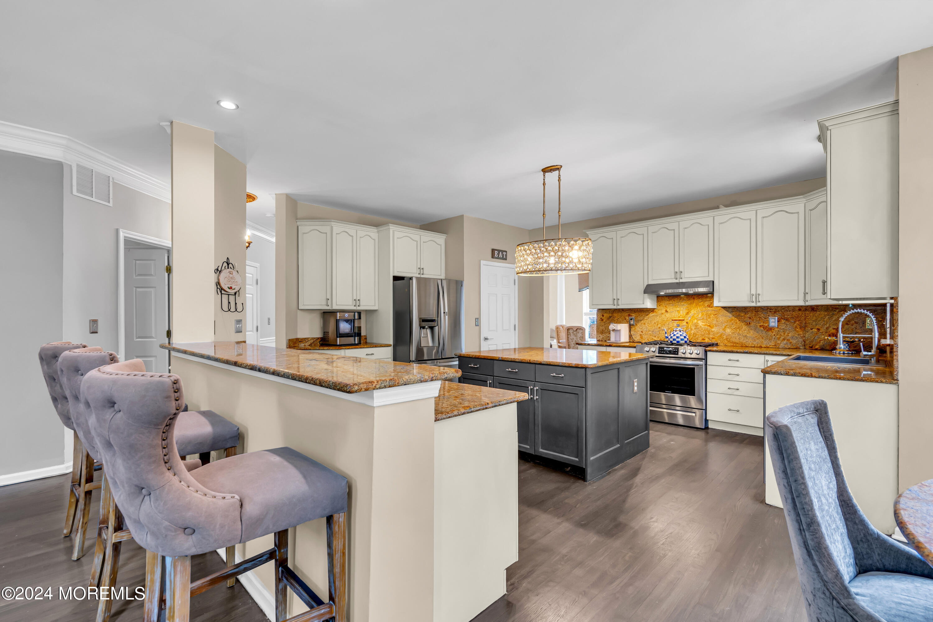 22 Cedar Knoll Road Jackson, NJ 08527 - Photo 22 of 76 a kitchen with stainless steel appliances granite countertop a stove top oven a sink a dining table and chairs