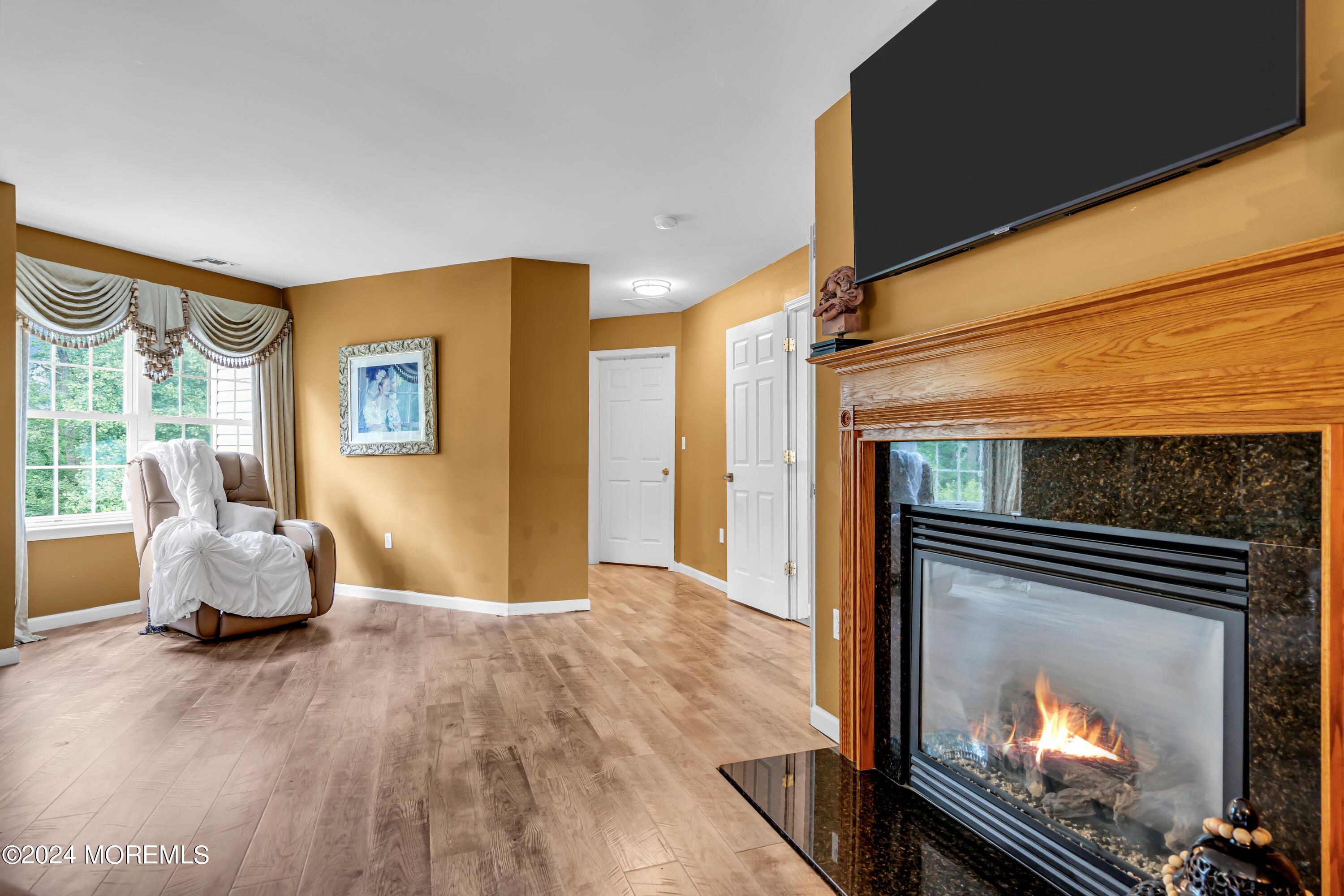 22 Cedar Knoll Road Jackson, NJ 08527 - Photo 42 of 76 a living room with furniture wooden floor and a fireplace