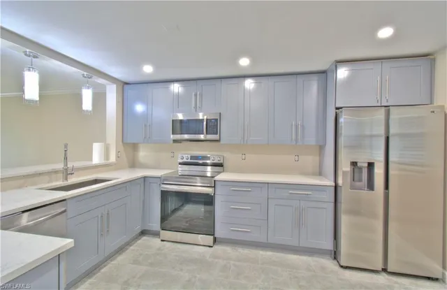 a kitchen with a sink stainless steel appliances and cabinets
