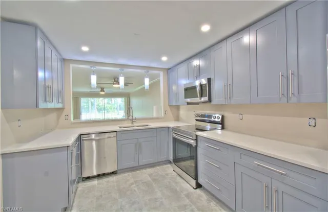 a kitchen with sink and cabinets
