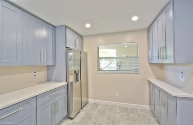 an empty room with windows and ceiling fan