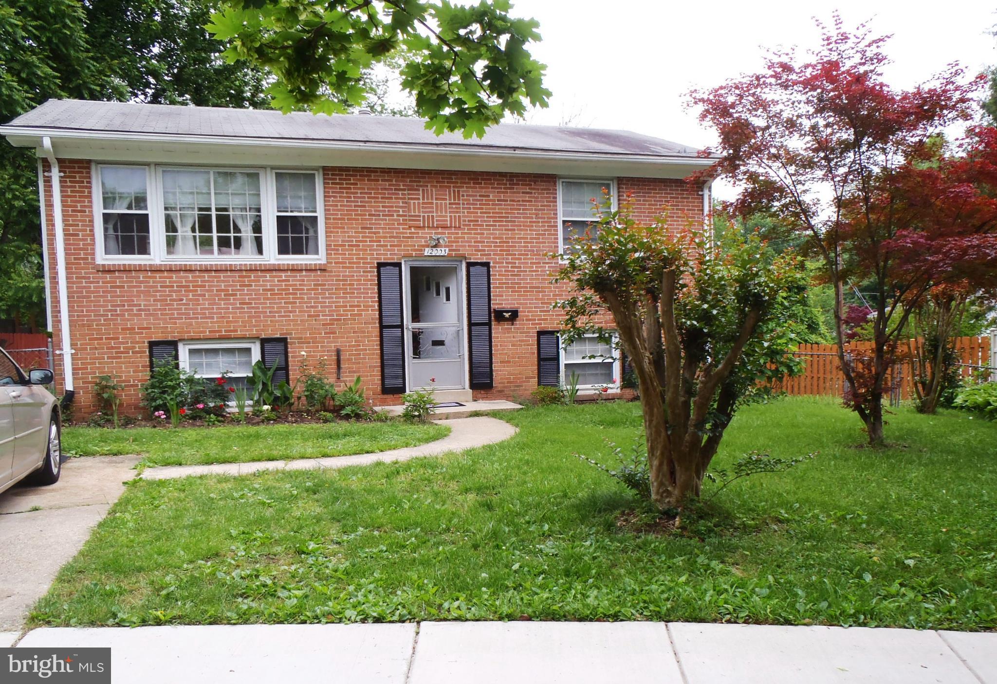Brick front, concrete driveway.