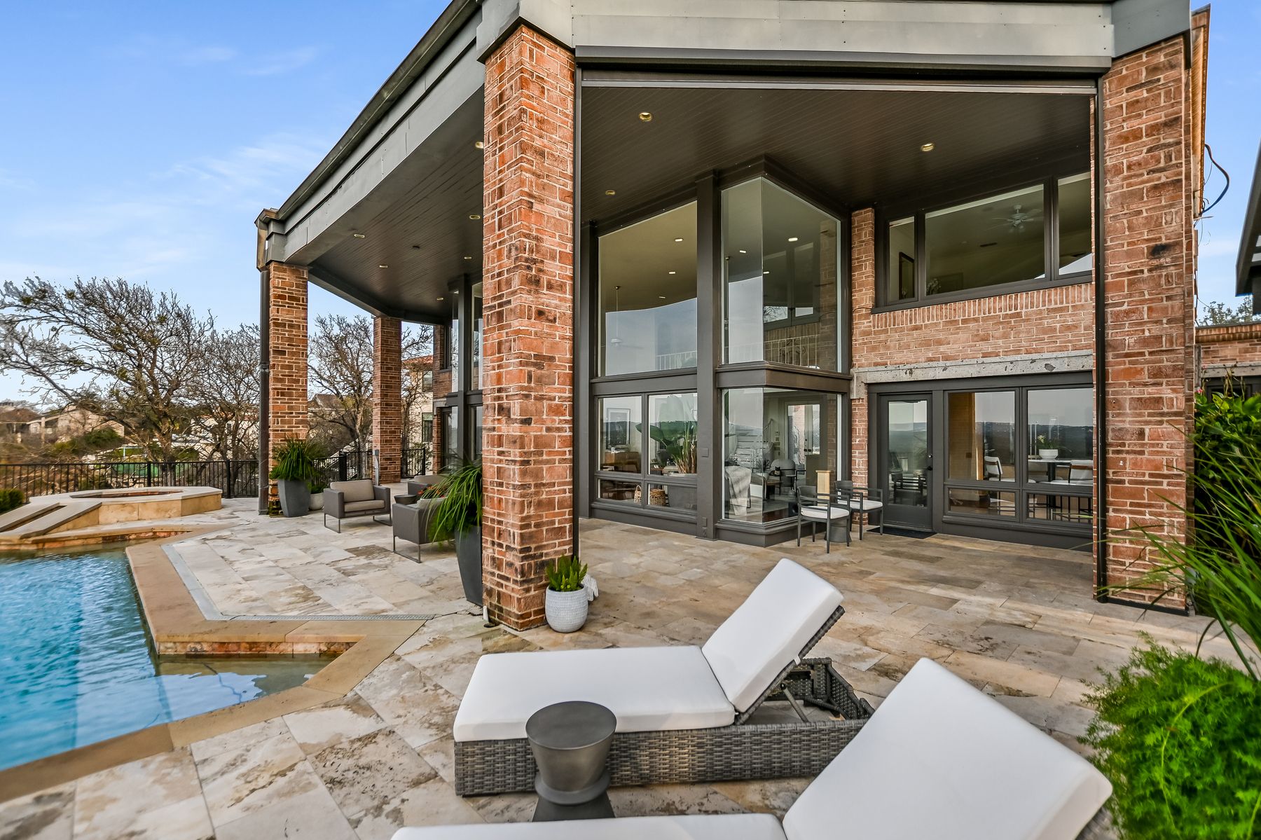 78 Pascal Lane Austin, TX 78746 - Photo 19 of 20 Outdoor entertaining space and back of home with expansive windows to enjoy the views.