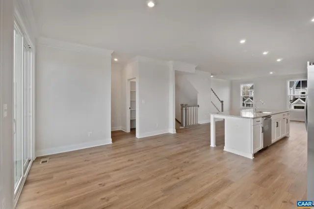 a view of a kitchen with wooden floor and electronic appliances