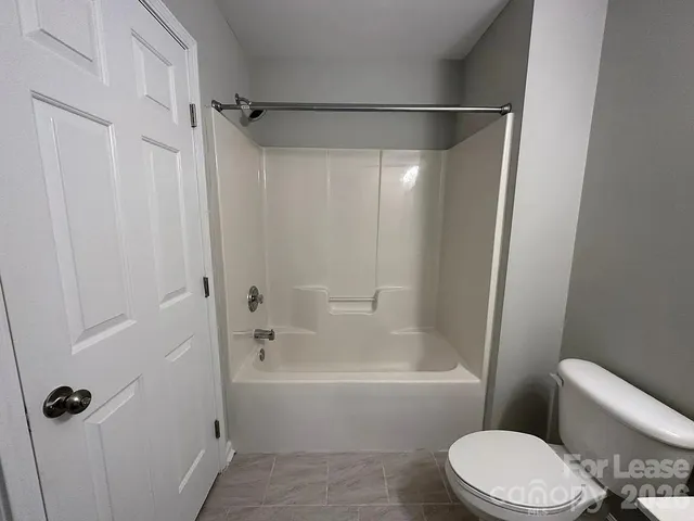 a bathroom with a toilet and a bathtub