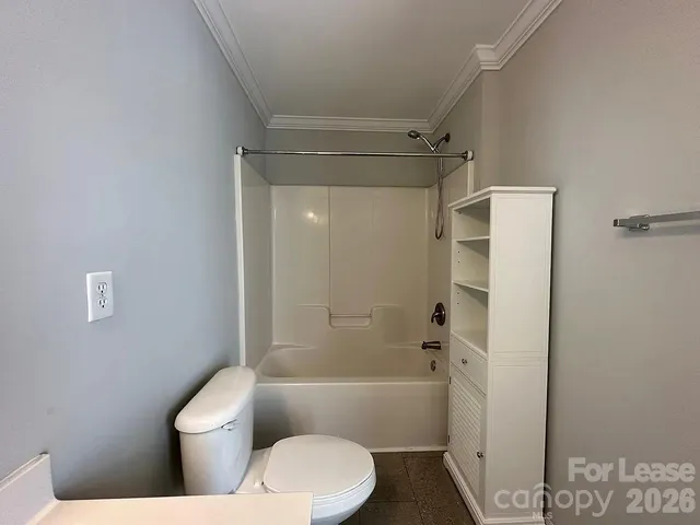 a bathroom with a toilet and a bathtub