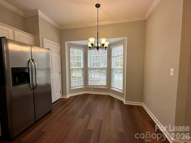 a view of a kitchen with a dishwasher cabinets and wooden floor