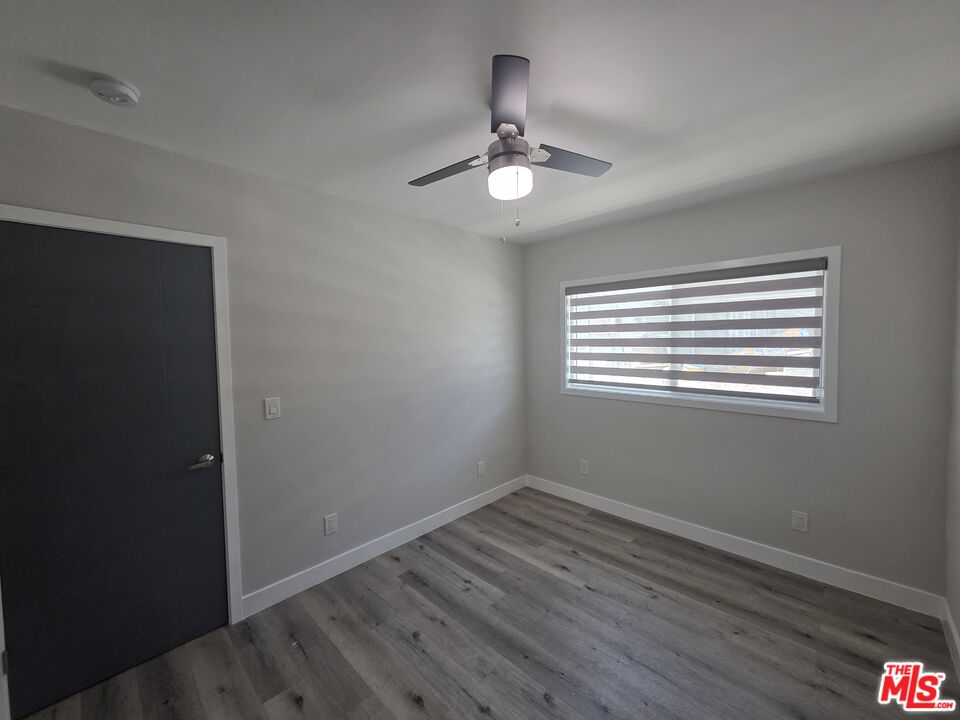 1505 South Cochran Avenue, Unit 4 Los Angeles, CA 90019 - Photo 12 of 45 a view of wooden floor and chandelier in a room