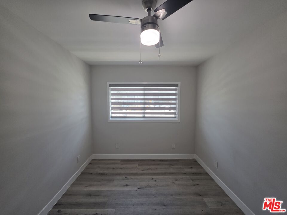 1505 South Cochran Avenue, Unit 4 Los Angeles, CA 90019 - Photo 13 of 45 a view of an empty room with wooden floor and a window