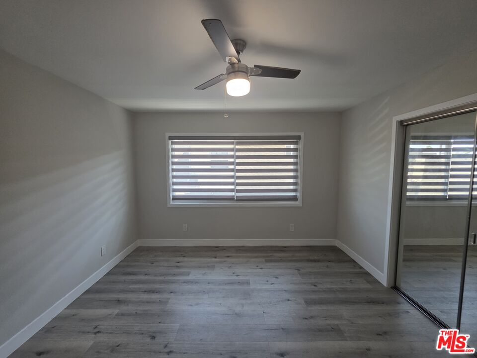 1505 South Cochran Avenue, Unit 4 Los Angeles, CA 90019 - Photo 15 of 45 a view of an empty room with wooden floor and a window