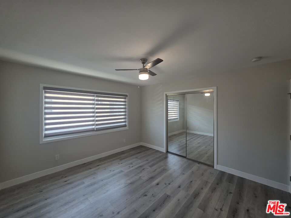 1505 South Cochran Avenue, Unit 4 Los Angeles, CA 90019 - Photo 16 of 45 a view of an empty room with wooden floor and a window