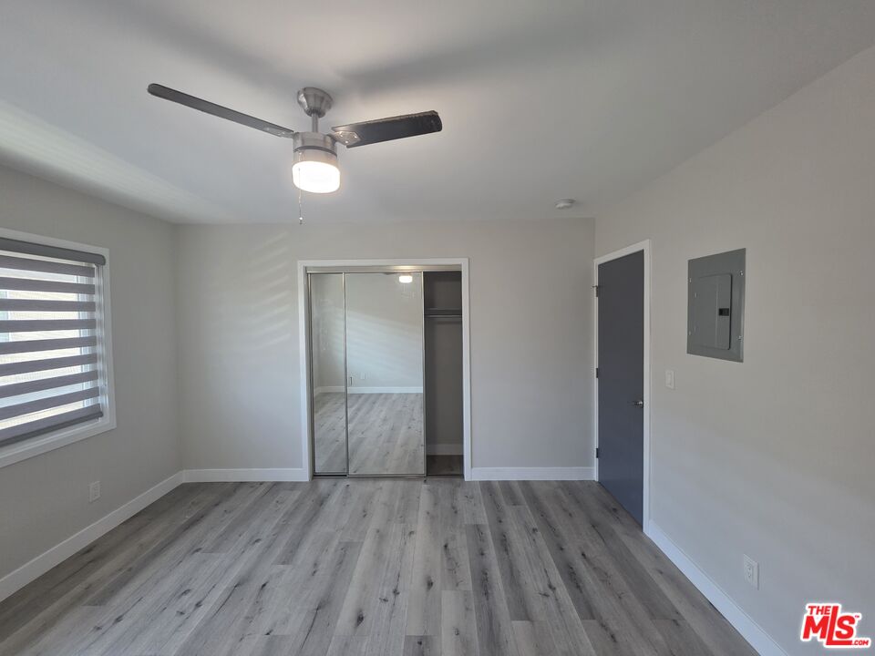 1505 South Cochran Avenue, Unit 4 Los Angeles, CA 90019 - Photo 17 of 45 wooden floor in an empty room with a window