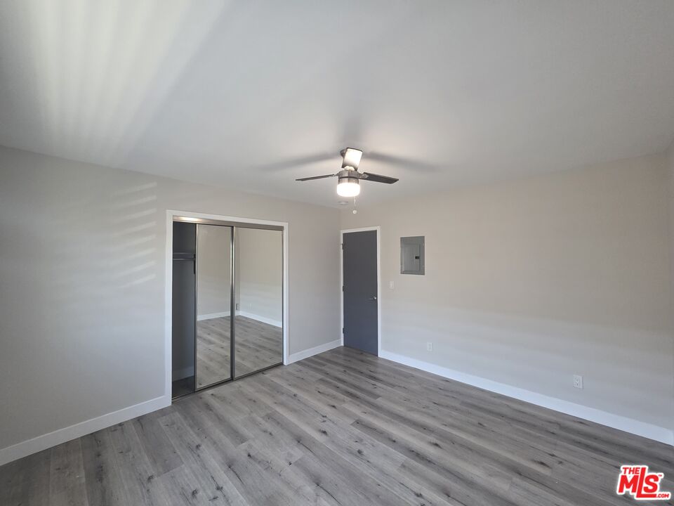 1505 South Cochran Avenue, Unit 4 Los Angeles, CA 90019 - Photo 18 of 45 a view of an empty room with wooden floor
