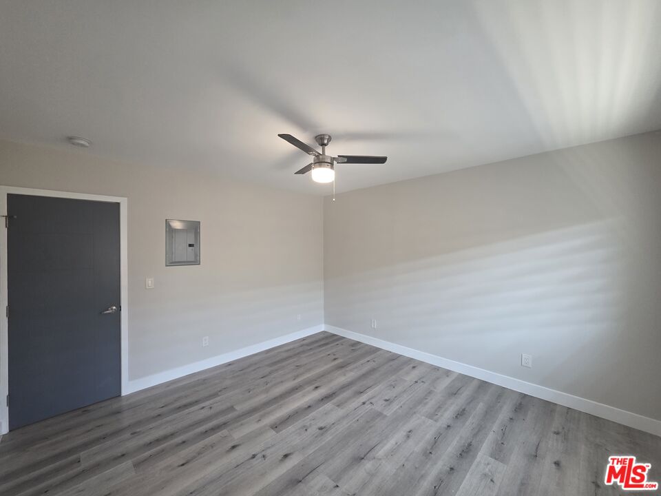 1505 South Cochran Avenue, Unit 4 Los Angeles, CA 90019 - Photo 20 of 45 a view of wooden floor and a chandelier fan in a room