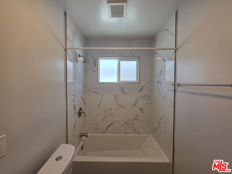 1505 South Cochran Avenue, Unit 4 Los Angeles, CA 90019 - Photo 23 of 45 a bathroom with a bathtub and a shower