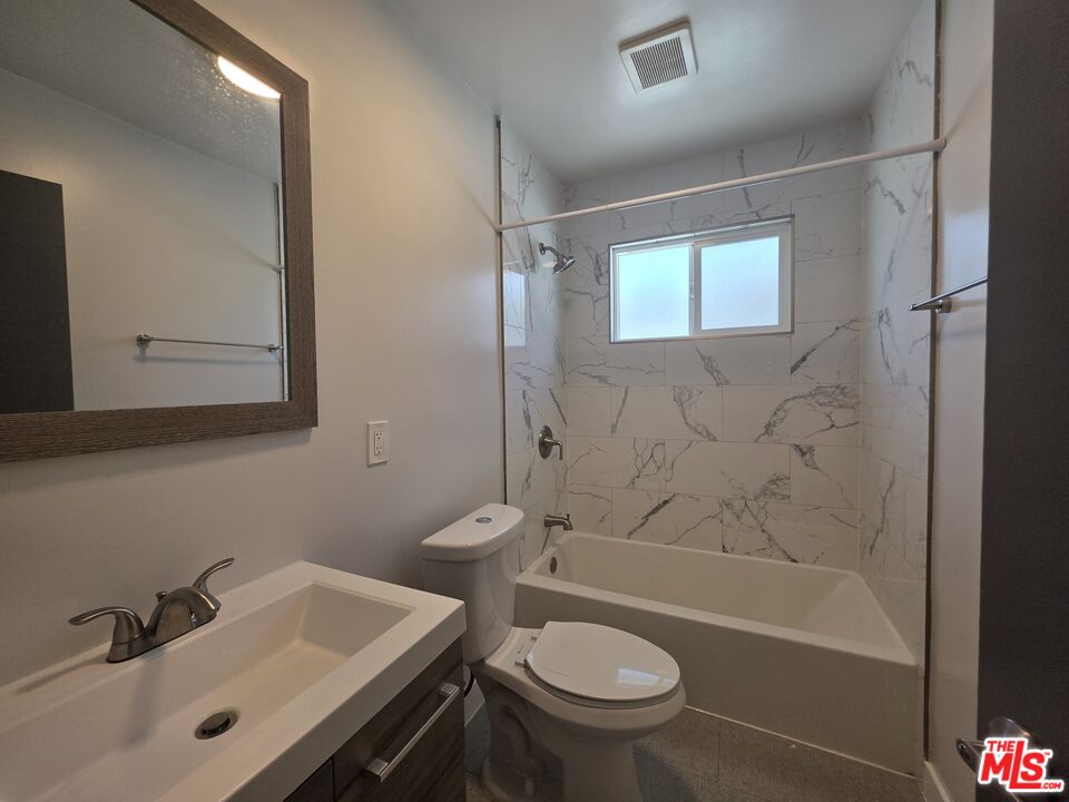 1505 South Cochran Avenue, Unit 4 Los Angeles, CA 90019 - Photo 26 of 45 a bathroom with a sink toilet and shower