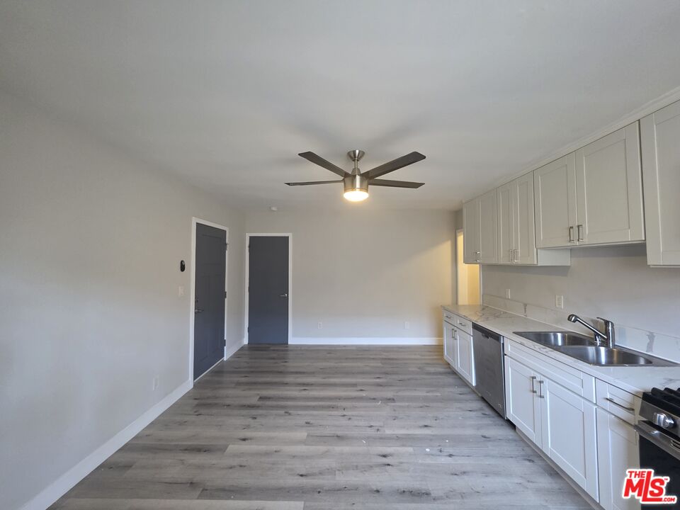 1505 South Cochran Avenue, Unit 4 Los Angeles, CA 90019 - Photo 3 of 45 a view of a kitchen with a sink and cabinets
