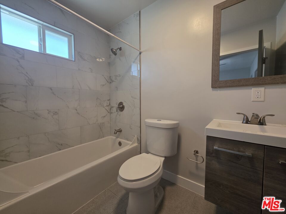 1505 South Cochran Avenue, Unit 4 Los Angeles, CA 90019 - Photo 31 of 45 a bathroom with a sink a toilet and shower