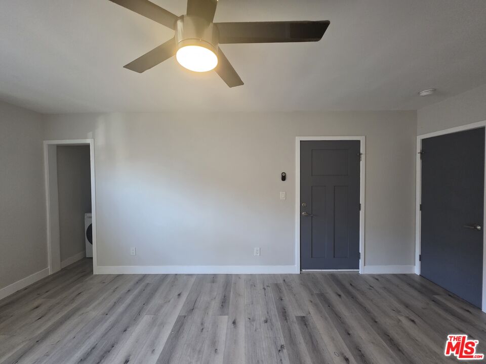 1505 South Cochran Avenue, Unit 4 Los Angeles, CA 90019 - Photo 35 of 45 a view of an empty room with wooden floor