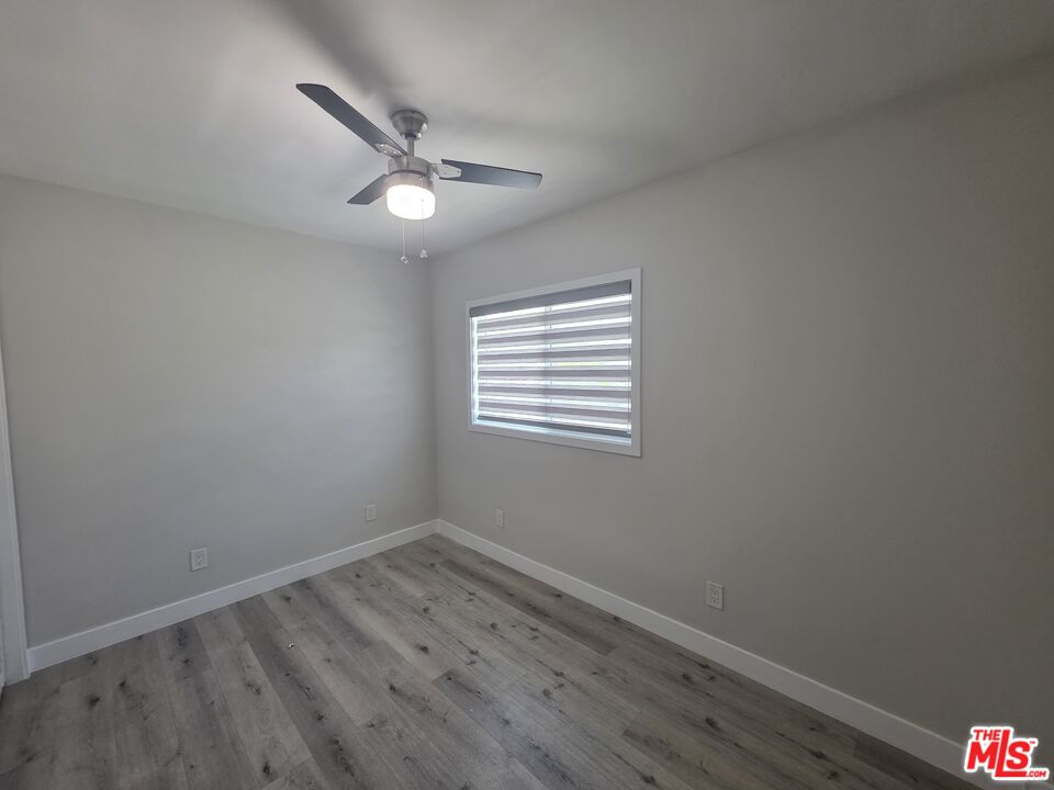 1505 South Cochran Avenue, Unit 4 Los Angeles, CA 90019 - Photo 37 of 45 wooden floor in an empty room with a window