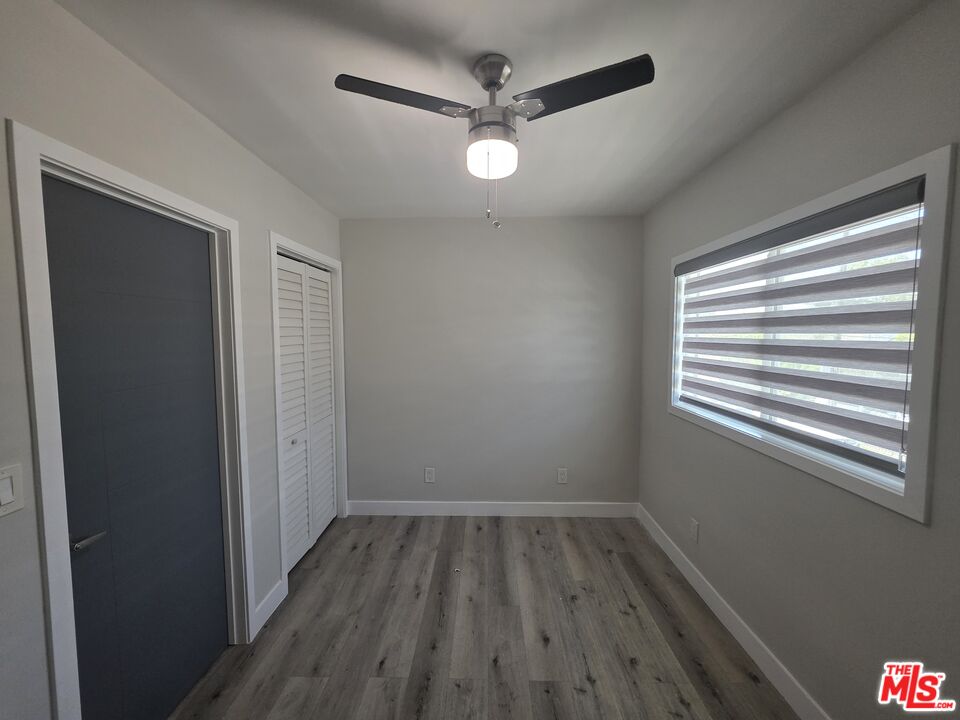 1505 South Cochran Avenue, Unit 4 Los Angeles, CA 90019 - Photo 38 of 45 a view of a room with wooden floor and windows