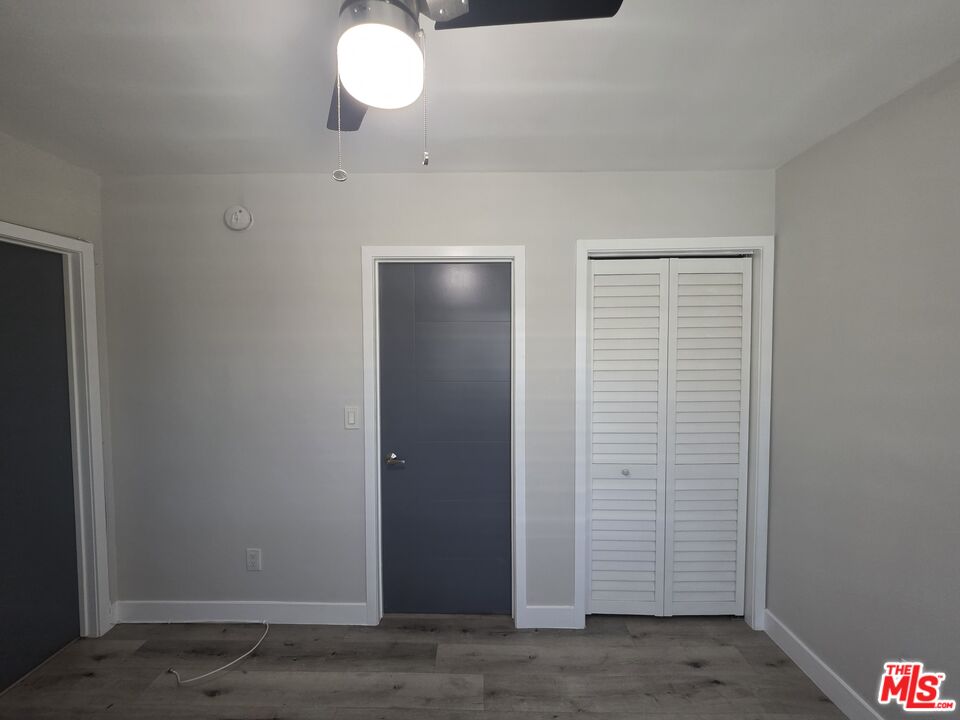 1505 South Cochran Avenue, Unit 4 Los Angeles, CA 90019 - Photo 40 of 45 an empty room with wooden floor and windows