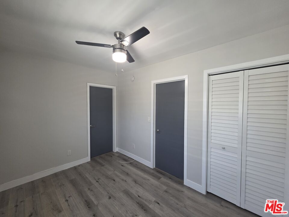 1505 South Cochran Avenue, Unit 4 Los Angeles, CA 90019 - Photo 41 of 45 a view of an empty room with wooden floor