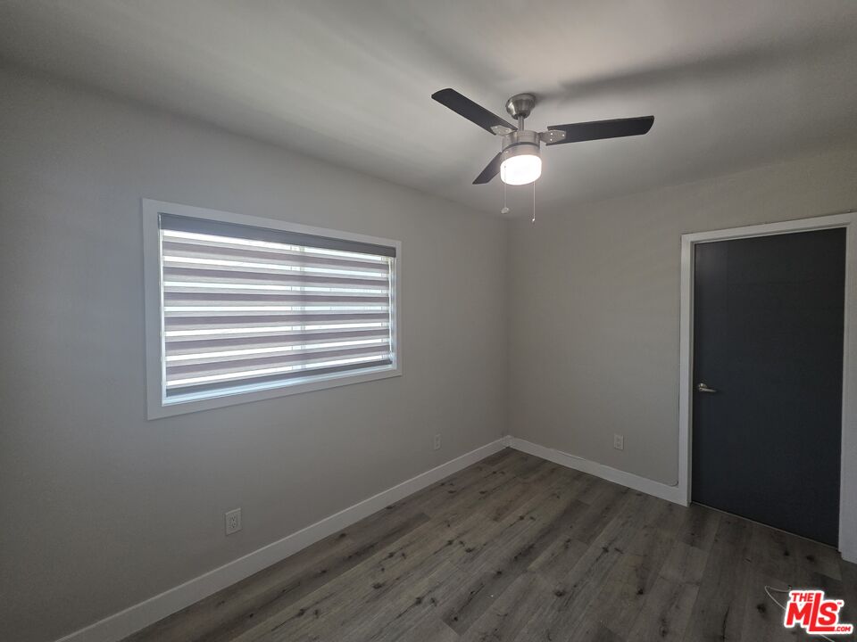 1505 South Cochran Avenue, Unit 4 Los Angeles, CA 90019 - Photo 43 of 45 a view of a room with wooden floor and windows