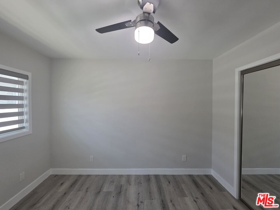 1505 South Cochran Avenue, Unit 4 Los Angeles, CA 90019 - Photo 7 of 45 wooden floor in an empty room with a window
