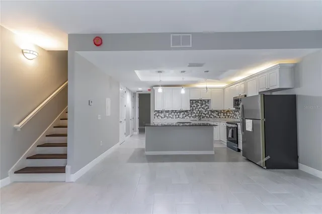 a bathroom with a granite countertop sink a toilet and bathtub