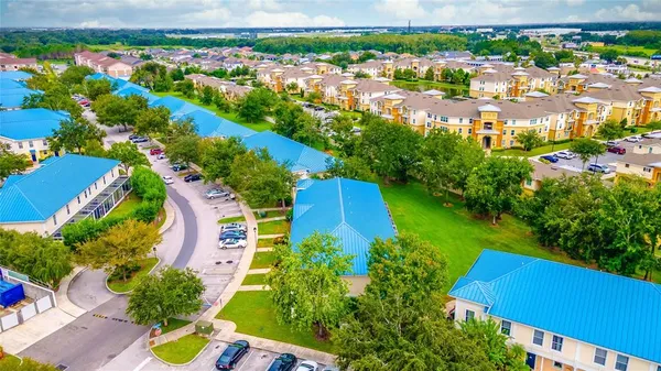 an aerial view of residential houses with outdoor space and street view