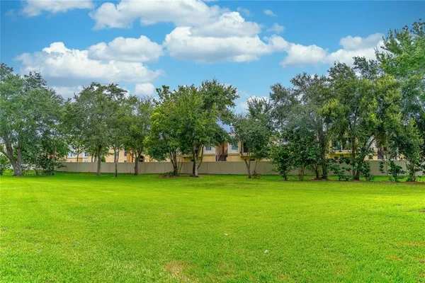 a front view of a house with a yard and trees