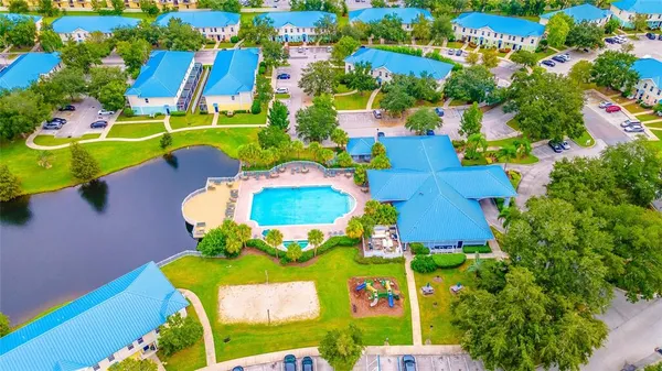 a view of a swimming pool with a yard and sitting area